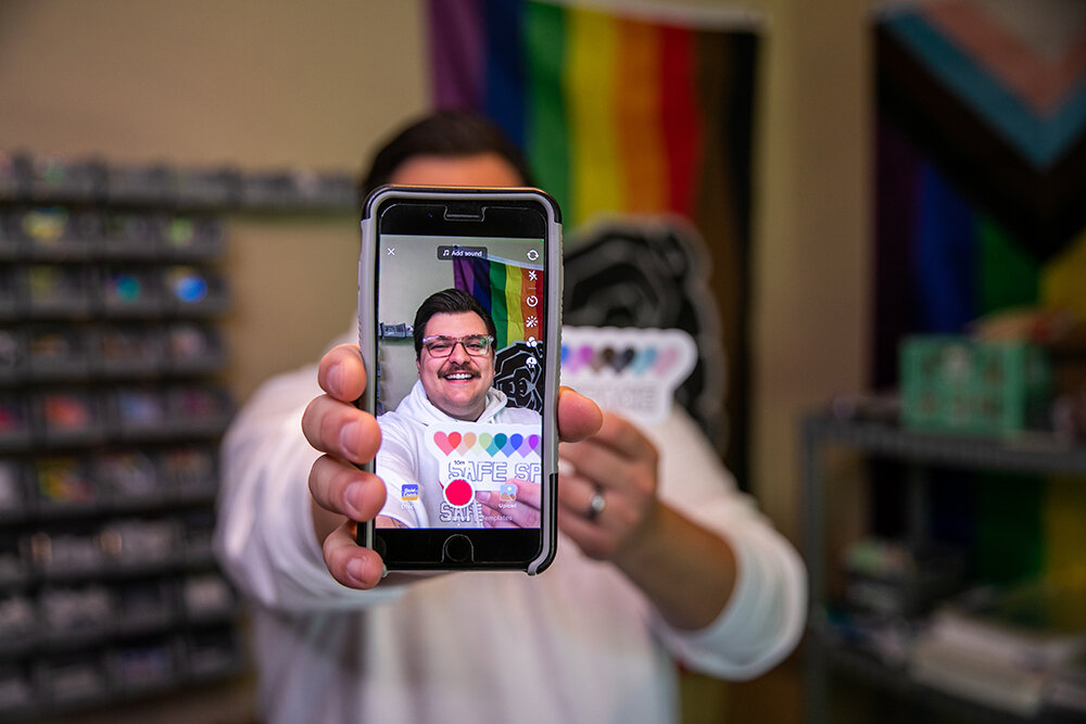 Aaron Schekorra displays his company's safe space sticker that identifies classrooms and offices as hospitable to LGBTQ+ people. Schekorra's business grew rapidly after trending on social media.