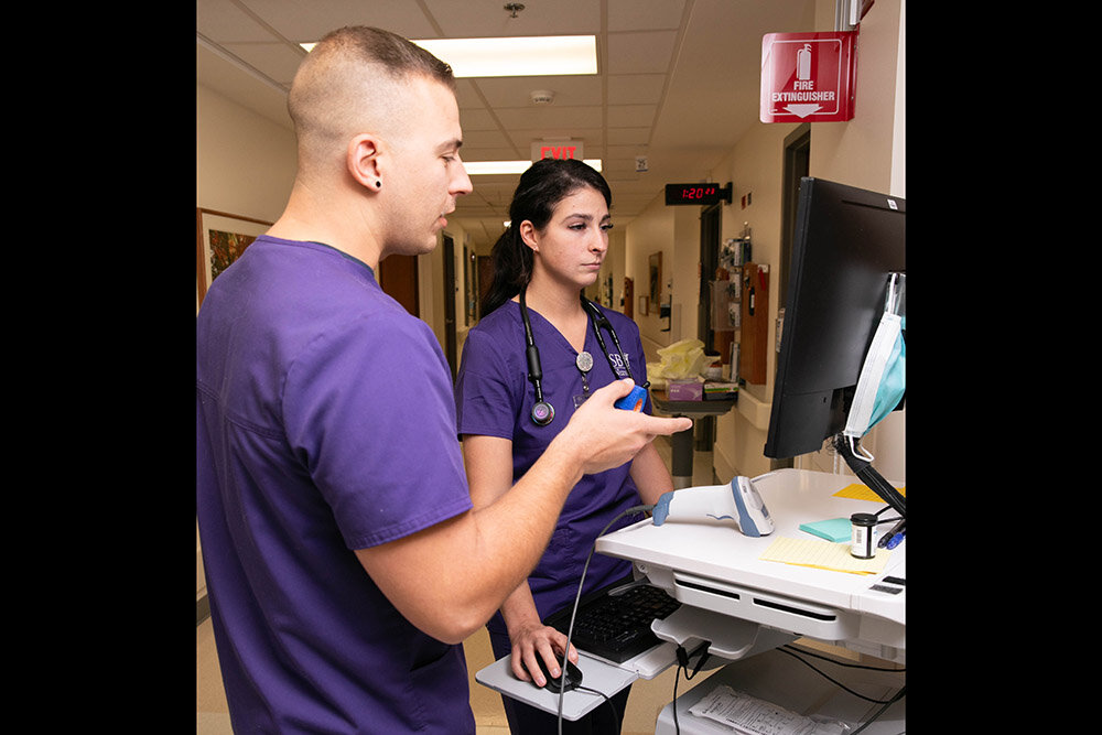 SBU nursing students Allen Werner and Megan Dennis review patient data.