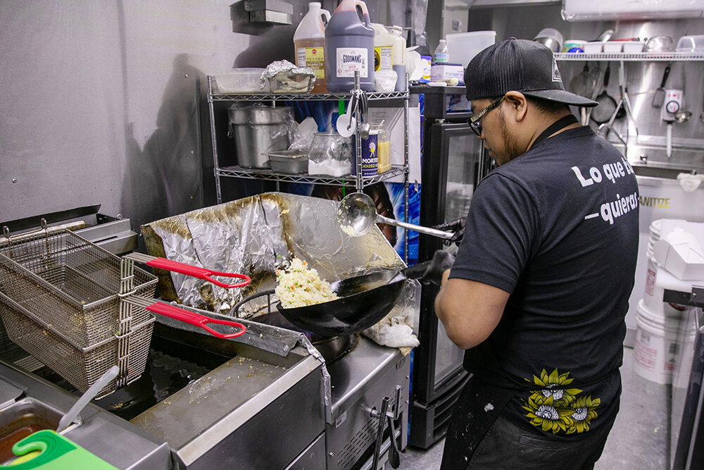 Sergio Hernandez prepares a dish in the Whatever You Want food truck, which recently opened at Metro Eats in west Springfield.
