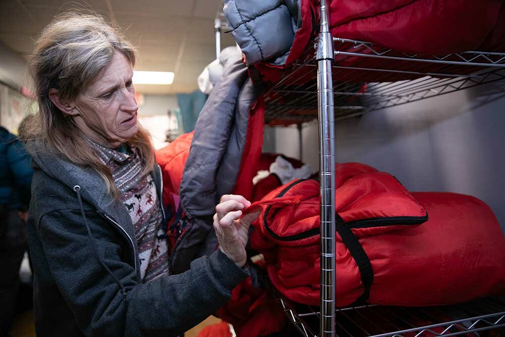 Tammy Pudas collects her bedding to set up her sleep station. An average of 30 women per night use Safe to Sleep shelter services, open throughout the year.